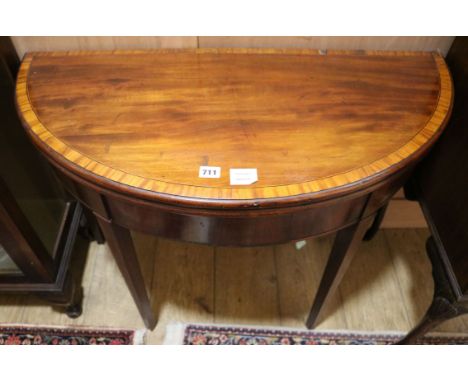 A George III mahogany and tulipwood banded 'D' shape card table W.91cm
