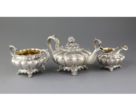 A William IV three piece silver melon shaped tea set, A.B. Savory &amp; Sons, with pumpkin finial, on scroll feet, London, 18