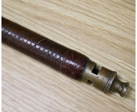 A hunting riding crop with brass whistle