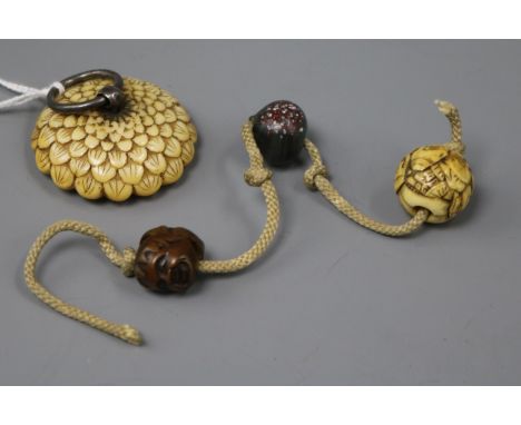 A Japanese ivory manju netsuke of a flower and three various ojime, 19th century