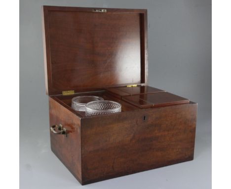 A large Regency mahogany tea caddy, of plain rectangular form, the lid opening to reveal two cut glass bowls and two large ca