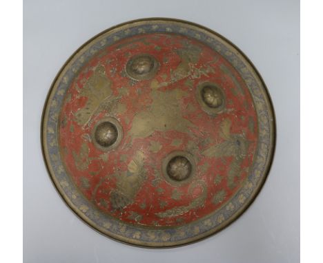 A Benares engraved brass and red enamel shield diameter 36cm