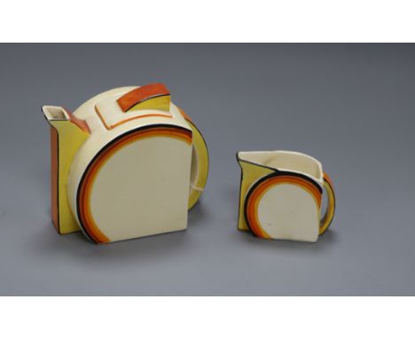 A Clarice Cliff Bizarre teapot and a matching cream jug
