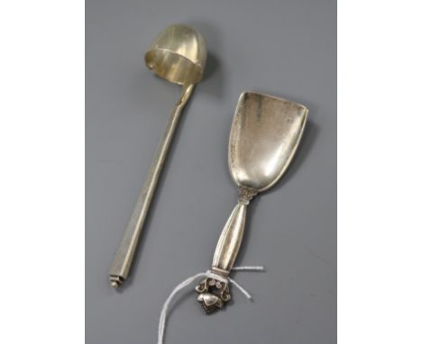 A 1930's Georg Jensen sterling silver cream ladle and a Georg Jensen silver caddy spoon.
