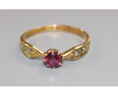 An early 20th century 18ct gold, single stone ruby ring, with diamond set shoulders, size K.