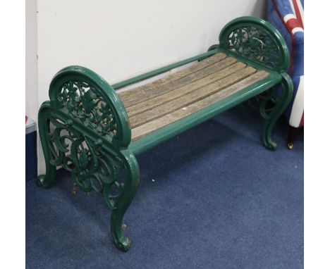 A Coalbrookdale cast iron green painted bench or window seat c.1870 with arched ends cast with with openwork, foliage and flo