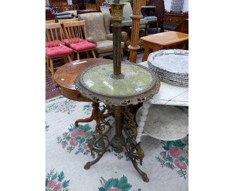 A GILT METAL TRIPOD STANDARD LAMP WITH A GREEN ONYX CIRCULAR TABLE AT THE CENTRE OF ITS HEIGHT.   H 160cms.