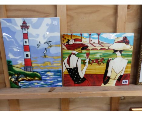 TWO DECORATIVE PORCELAIN PLAQUES, ONE WITH A COASTAL LIGHT HOUSE THE OTHER OF A HORSE RACE. 28 x 36cms (2)