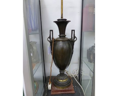 A ANTIQUE BRASS LAMP OF CLASSICAL STYLE FORMERLY DISPLAYED IN THE GREAT HALL AT MADAME TUSSARDS.