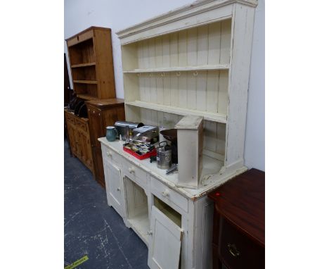 A WHITE PAINTED PINE DRESSER WITH ENCLOSED TWO SHELF BACK, THE BASE WITH AN OPEN SHELF FLANKED BY CUPBOARDS.   W 154 x D 60 x