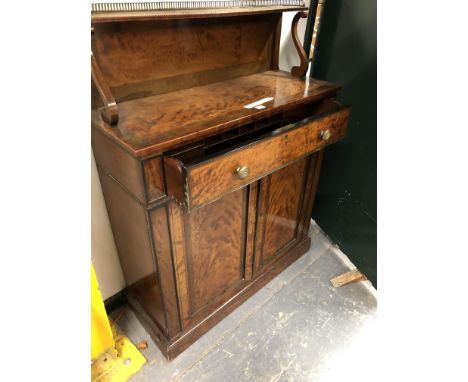 A REGENCY SATINWOOD SIDE CABINET WITH A THREE QUARTER GALLERIED, CROSS BANDED AND EBONY LINE INLAID SHELF RECESSED ABOVE, THE