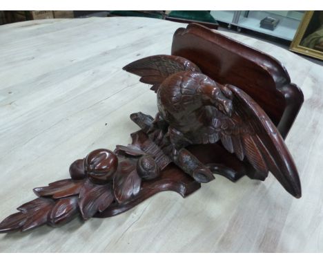 A VICTORIAN MAHOGANY WALL SHELF SUPPORTED ON THE BACK OF A SPREAD EAGLE ON A BRANCH ABOVE POMEGRANATES AND FOLIAGE.&nbsp; &nb