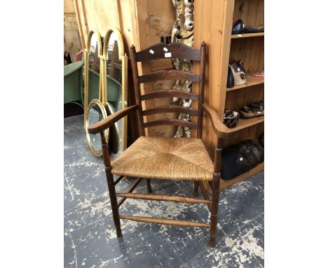 A COUNTRY MADE LADDER BACK RUSH SEAT ARMCHAIR