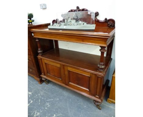 A VICTORIAN MAHOIGANY BUFFET WITH FOLIAGE SCROLL CARVED BACK, APRON DRAWER, A CUPBOARD BELOW THE OPEN SHELF ABOVE THE FOLIATE