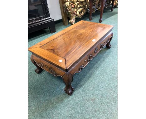  A CHINESE HARDWOOD LOW TABLE, THE RECTANGULAR TOP ABOVE AND SCROLL CARVED APRON AND LEGS ON BALL AND C;LAW FEET. W 76.5 x D 