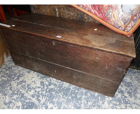 AN OAK TRUNK OR COFFER WITH IRON HANDLES TO EACH NARROW SIDE.   W 106 x D 40 x H 45cms.