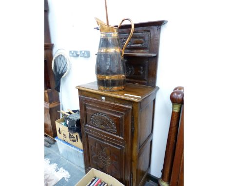 AN ANTIQUE FRENCH OAK SIDE CABINET, THE TWO SHELF BACK RECESSED ABOVE A CARVED TWO PANEL DOOR ENCLOSING SHELVES.   W 71 x D 4