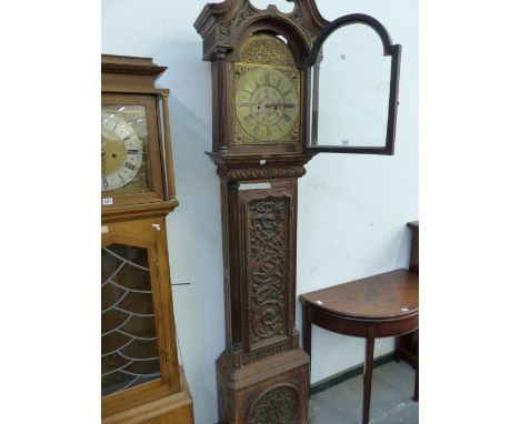 A 19th C. CARVED OAK LONG CASE CLOCK, THE ARCHED BRASS DIAL INSCRIBED WITHIN THE CHAPTER RING.   H 113cms.
