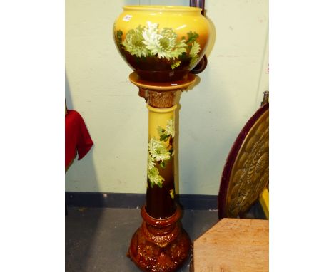 A BURMANTOFTS PLANTER AND STAND SHADING FROM YELLOW TO TONES OF BROWN, BOTH PAINTED WITH WHITE DAISIES, THE OVERALL HEIGHT.&n