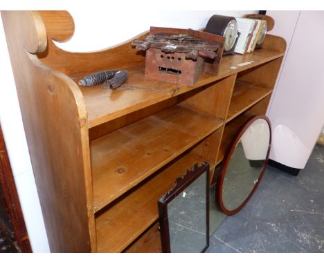 A 20th C. PINE OPEN BOOKCASE, THE SHAPED BACK OVER A LONG SHELF AND TWO BANKS OF THREE SHELVES.   W 168 x D 30 x h 123.5cms.