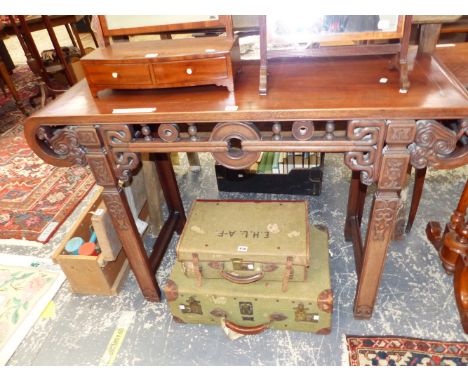 A CHINESE HARD WOOD ALTAR TABLE, THE ROLL OVER NARROW ENDS PIERCED WITH CHAIN MOULDINGS, THE APRON CARVED WITH SPINDLES AND R