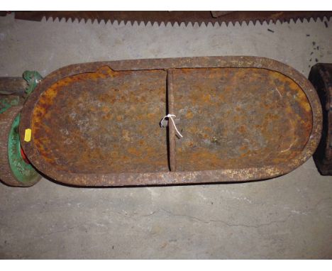 A small cast iron pig trough