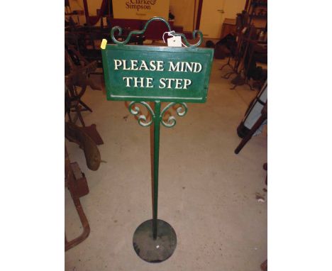 A "Please Mind The Step" metal sign