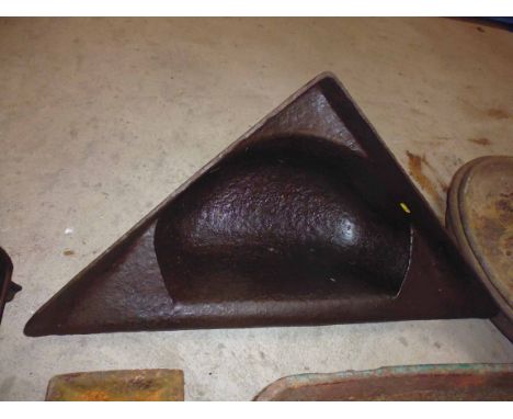 A cast iron corner  mounted feed trough