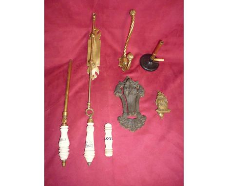 Three old ceramic and brass toilet pulls; a brass hook; a brass door knocker; a cast iron similar and a Bunsen Burner