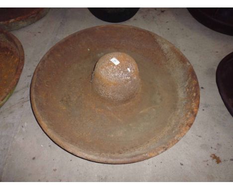 A cast iron pig trough