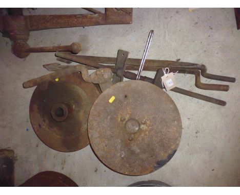 A Ransomes plough disk, fly wheel, two roofing tools etc.