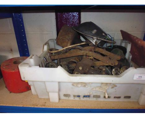 A box containing an old foot pump, cycle bell, engine spares etc.