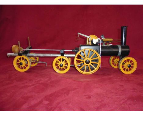 A Mamod steam tractor with timber trailer