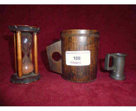 An Antique wooden measure, 18cm high; a treen egg timer, 9cm; and a French pewter "Gentilitre" measure, (3)