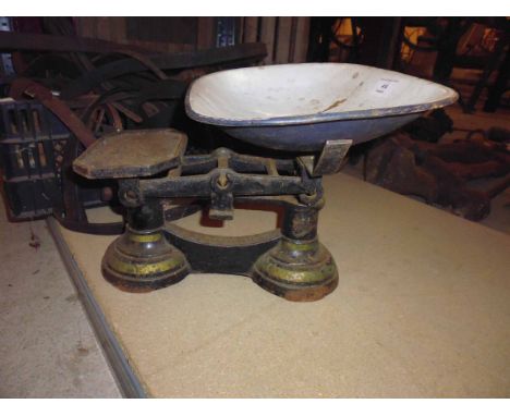 A small balance scale with enamel bowl