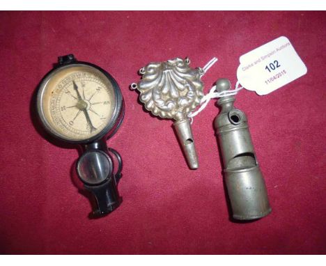 Two Antique whistles; and a magnifier/compass, (3)