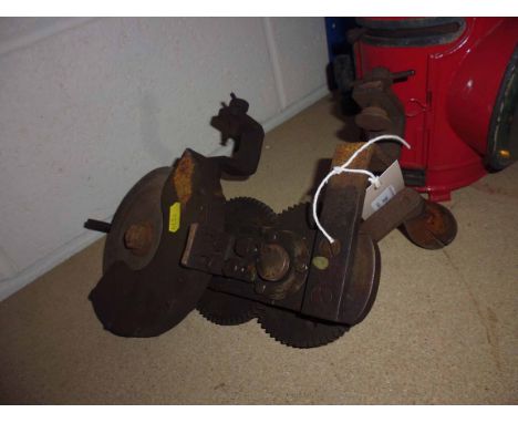 A bench mounted hand operating grinding wheel