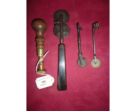 A 19th Century horn handled steel pastry cutter, 21cm long; two smaller examples; and a butter stamp, (4)