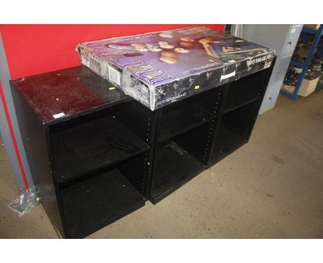Three black wooden shelf units