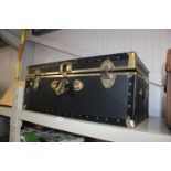 A leatherette and brass travelling trunk