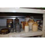 A collection of various stoneware jars, some named