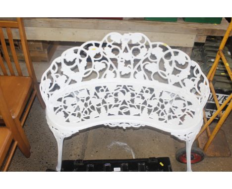 An ornate metal bench with grape and vine leaf decoration