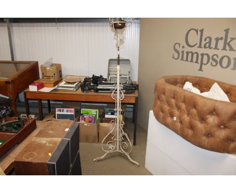 A wrought iron adjustable standard lamp
