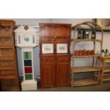 A pine dresser raised on cupboard base fitted two