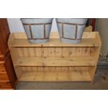 A stripped pine open fronted bookcase