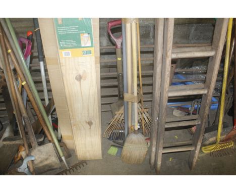 A collection of gardening tools and brooms