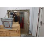 An ornate framed and bevel edged wall mirror