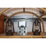 An RCA manufacturing Co electronic voltmeter, together with two oil lamps