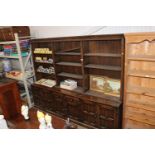 A large oak display cabinet, raised on cupboard ba