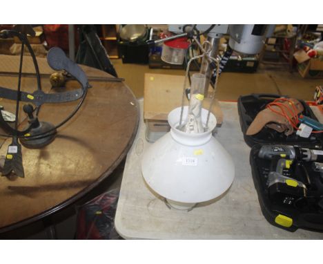 A hanging glass oil lamp